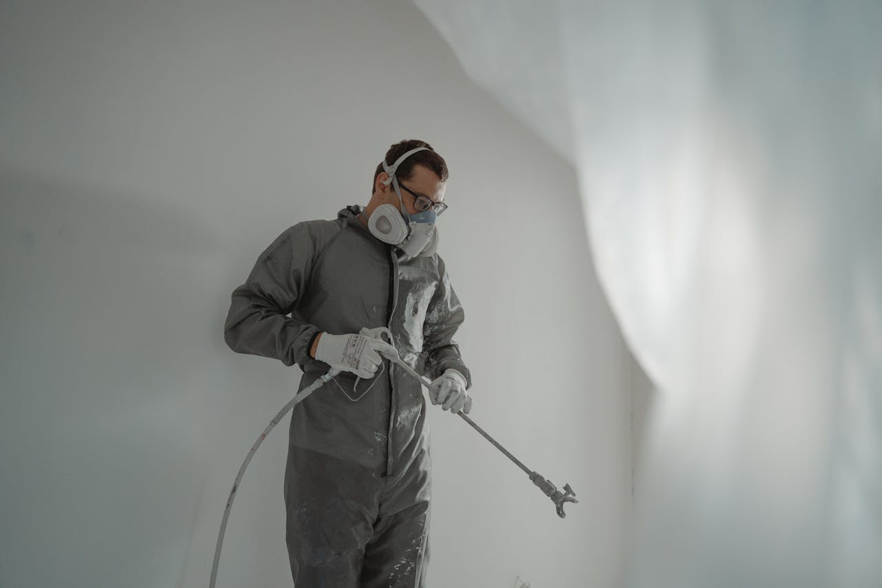 Professional painter at work on interior walls
